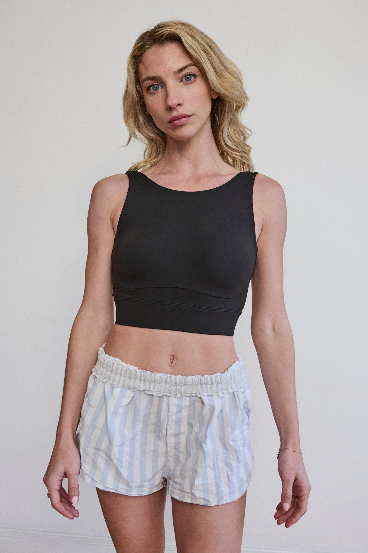 Woman wearing a black bralette for small bands and large cups